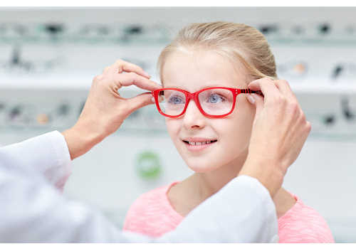 kid trying on glasses